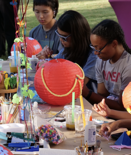 Students outside of the Museum creating paper lanterns