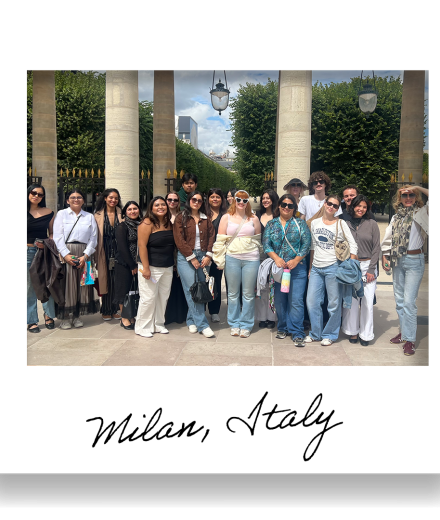group of people pose together among stone columns