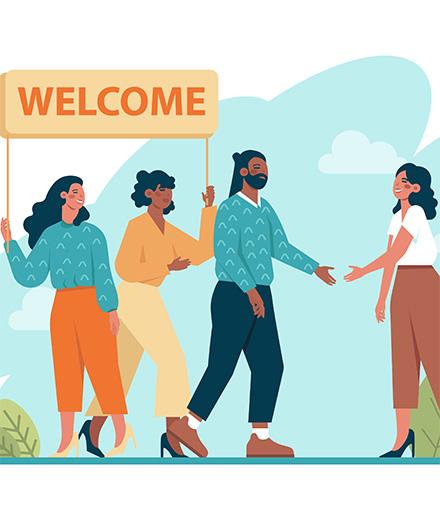 people greeting new person and holding sign that says welcome