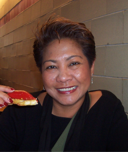 Smiling woman holding food.