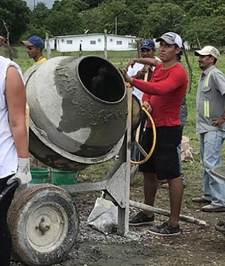 Volunteers working with cement