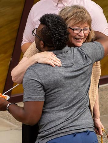 President Conoley hugging someone at Convocation 2018