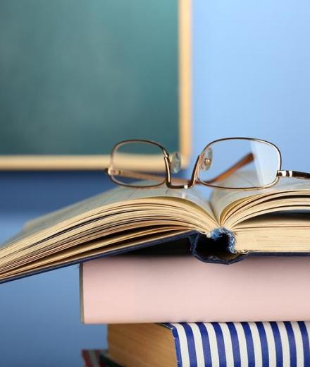 stacked book with glasses on top
