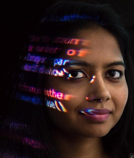 Female student with coding imposed on her face
