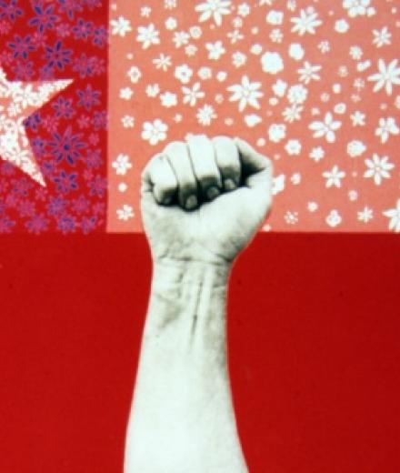 Photo of hand in fist above texas flag