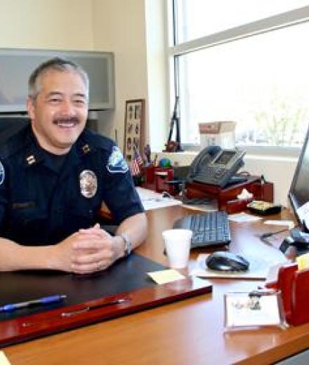 Director Ron Mark sitting at his desk