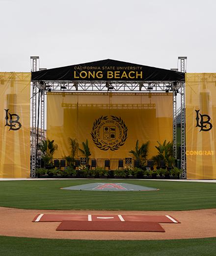 stage for graduation set up in baseball field