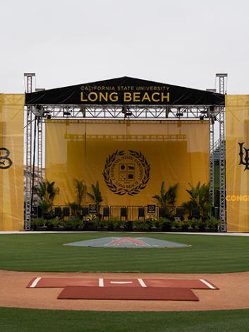 stage for graduation set up in baseball field