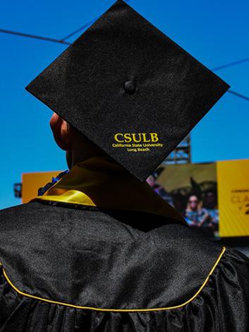 student with CSULB graduation cap