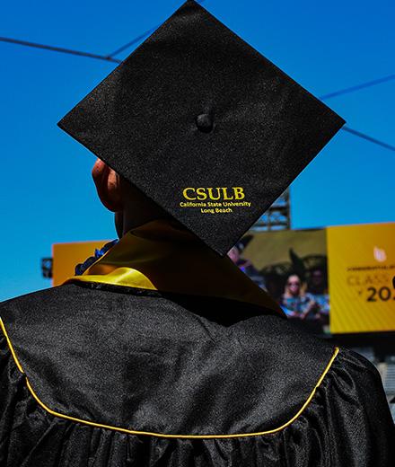 student with CSULB graduation cap