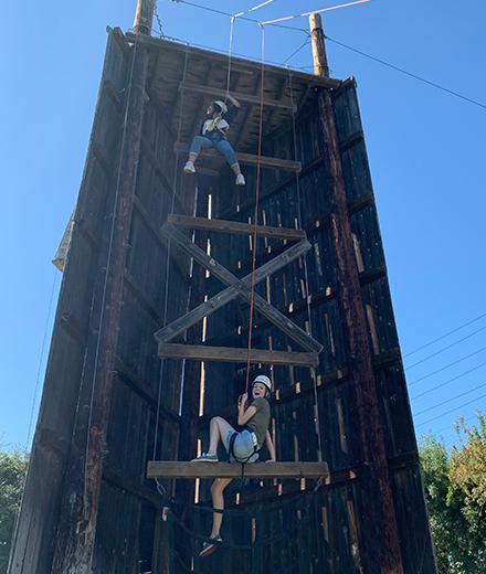 students scaling a wall