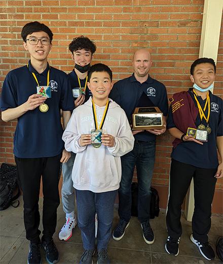 Math Day winners holding trophies and medals