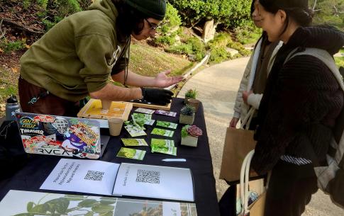 Student demonstrates plant seeding techniques to other students.