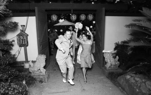 Wedding guests dance out of the front gate of the Japanese Garden.