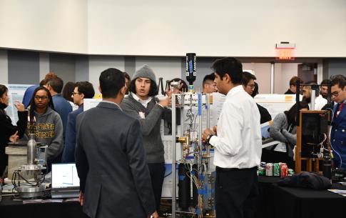 Student explaining rocket test stand