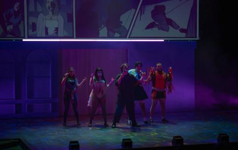 a cast of people in halloween costumes dance on stage