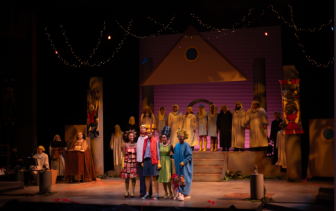 a futuristic cast of simpsons stands on stage