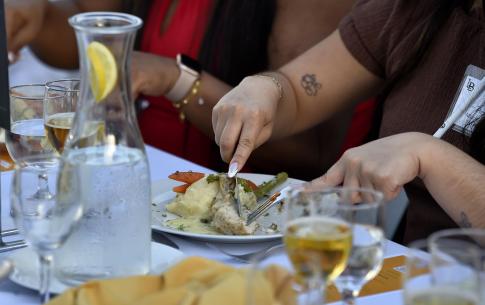 Student close-up of knife and fork etiquette practice