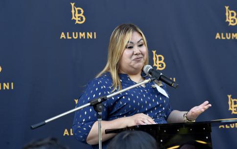 Director of Alumni Engagement Noemi Guevara addresses the graduates