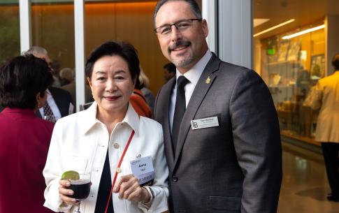 Woman holding drink next to man