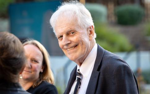 Man with white hair smiling