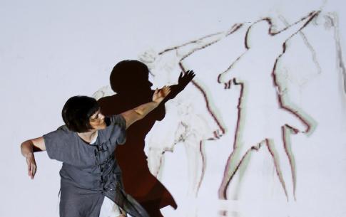 Rebecca Bryant dancing in front of projections