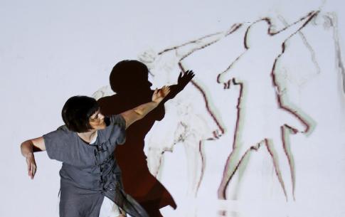 Rebecca Bryant dancing in front of projections