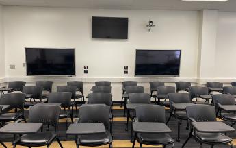 three monitors in back of classroom