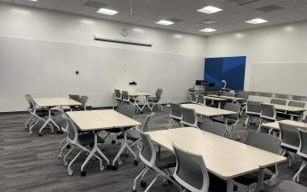 large whiteboards and tables for student collaboration