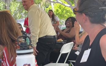 A man stands up to be recognized at convocation celebration.