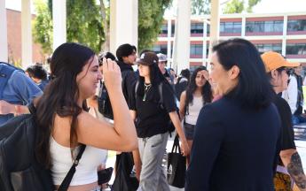 Dean Rhee talking with students at opening