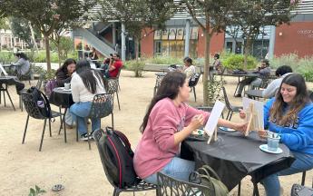 students sitting and painting