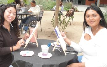 two students sitting and posing
