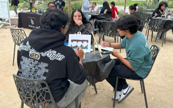 Students sitting and painting
