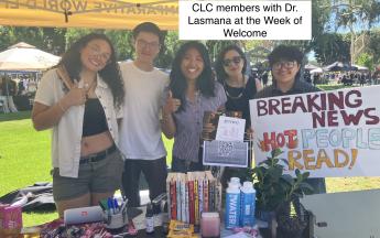 people under a canopy holding a sign