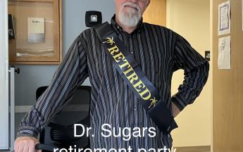 man wearing sash saying retired