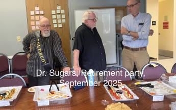 three people standing around a table