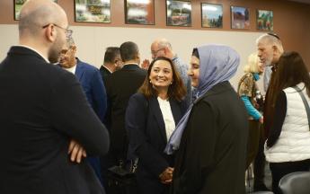 three people talking in foreground