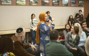 person speaking into microphone in a group