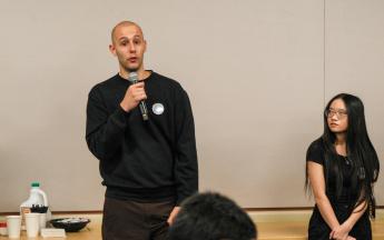 student speaking into microphone