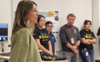 A female Marketing Professor presenting at day at the beach