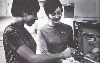 Connie Taylor, Home Economics Club President, and Kathy Ulrich, Historian, check on a roast cooked according to the newest addition of the club cookbook. 