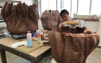 Artist in residence MyungJin “MJ” Kim working in the Ceramic Arts studios, 2019.