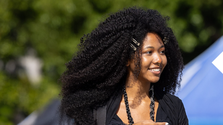 CSULB student smiling while on campus