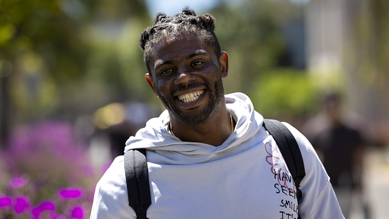 Student smiling at Day at The Beach event