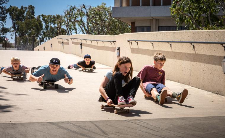 Kids skateboard on the CSULB campus