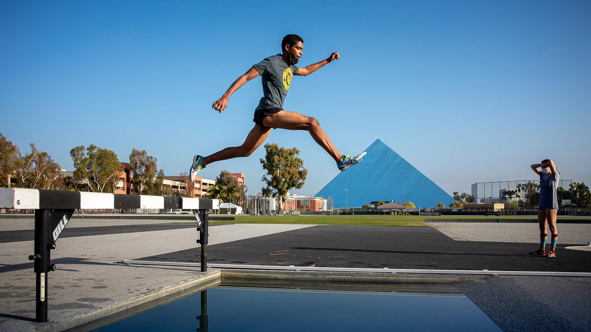Track & Field runner leaps the Walter Pyramid