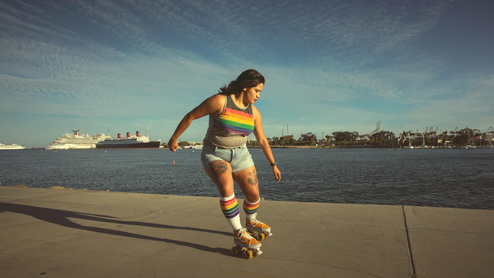 Woman roller-skates on a path in Rainbow Harbor