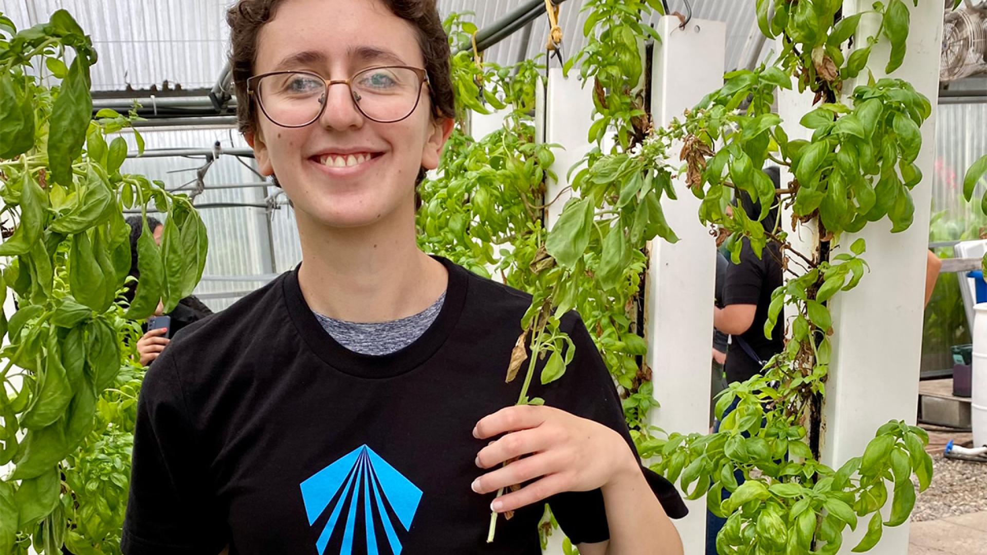 student holding basil
