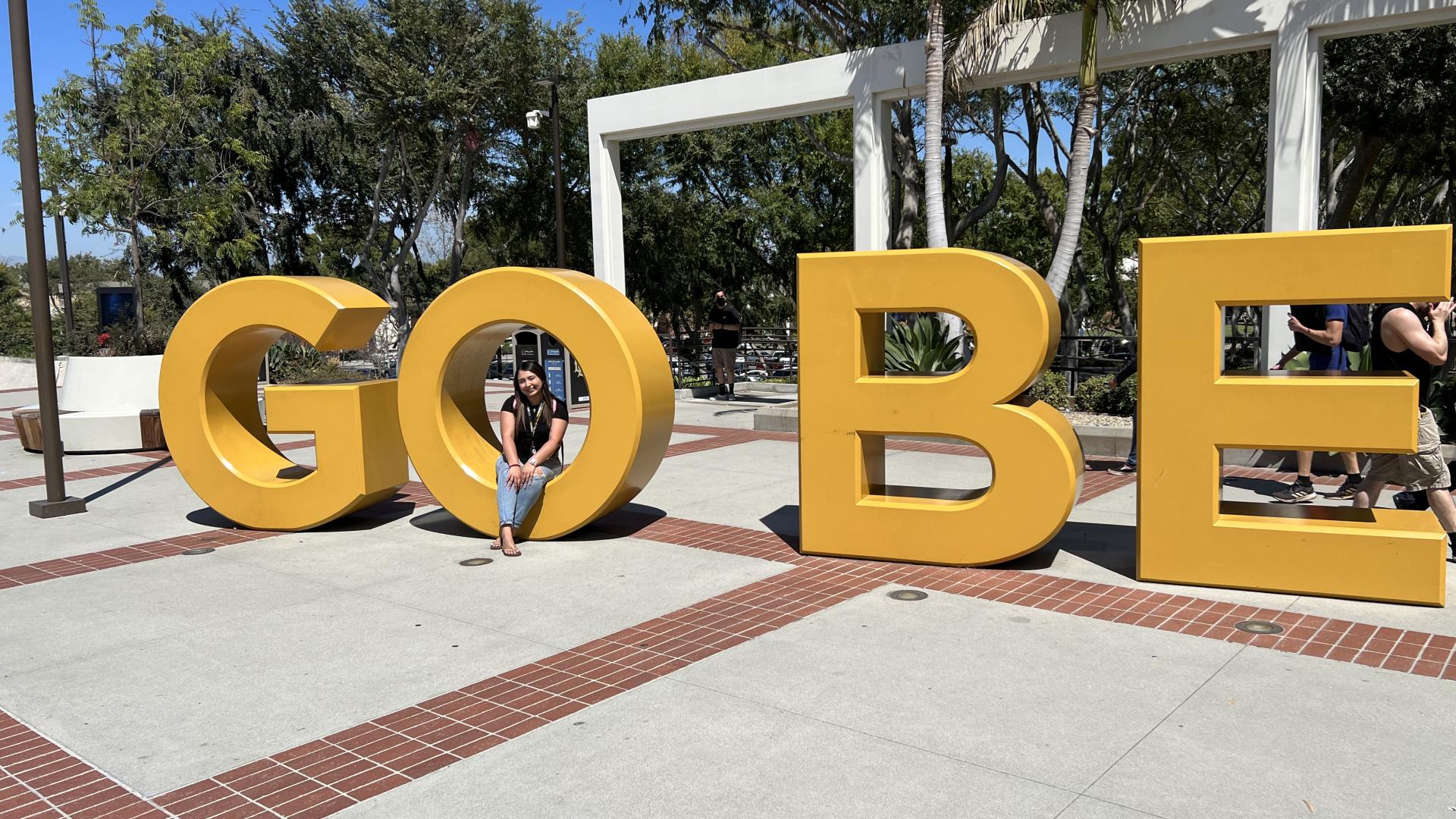 Valerie at the Go Beach Sign 